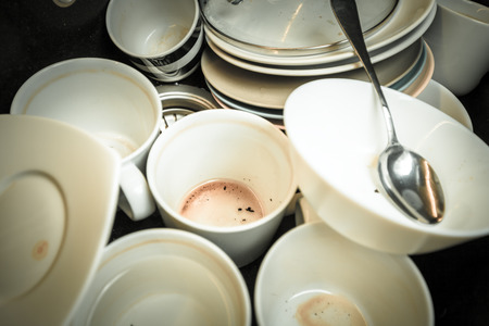 Dirty dishes in the black sinkの写真素材