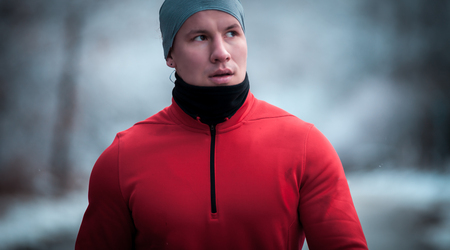 Athlete man wearing warm sporty running clothes, winter exercise outdoor