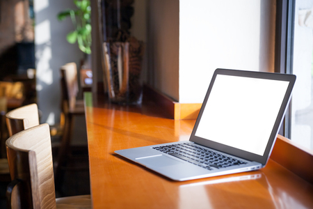 Mockup image of laptop with blank screen on table at cafeの写真素材