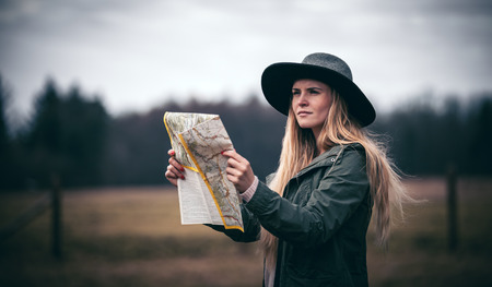 Rural scene with traveler woman in hat with map, melancholic autumn moodの写真素材
