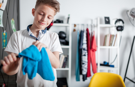 Preteen boy doing housework and cleaning his roomの写真素材