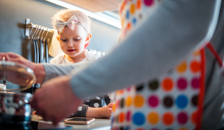 Little child girl in the kitchen having fun with her dad, family lifestyleの写真素材
