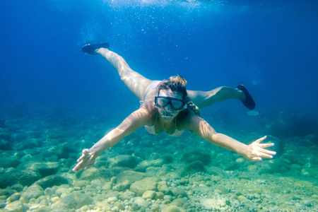 Women diving in the tropical water, snorkeling with maskの写真素材