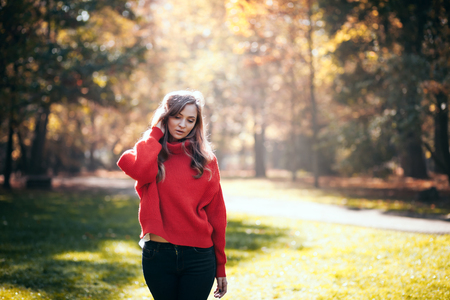 Natural woman in soft warm knitted sweater walking outdoorsの写真素材