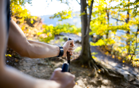 Man on trail holding trekking sticksの写真素材