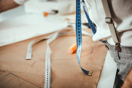 Fashion designer desk with equipment, tailoring and sewing workshop concept