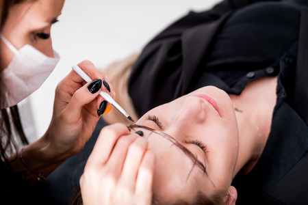 Permanent make up on eyebrows at beauty salonの写真素材