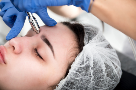 Professional skin care, procedure Microdermabrasion of the facial skin at cosmetic clinic