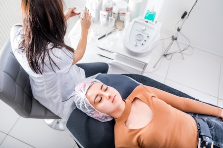 Young woman laying in beauty salon waiting for treatmentの写真素材