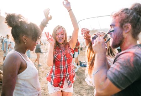 Dancing colorful people at summer holi festivalの写真素材