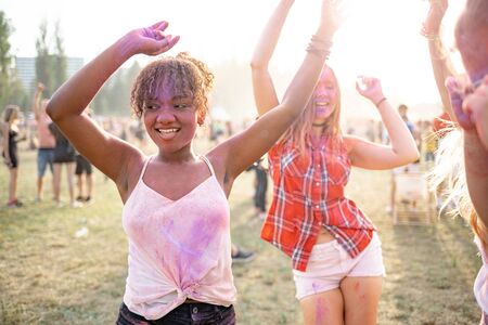 Dancing colorful people at summer holi festivalの写真素材