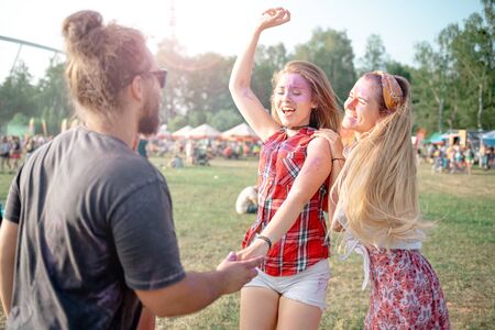 Friends covered with color powder having fun at holi festival