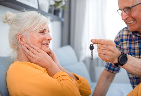 Senior husband giving keys of new house to his wife