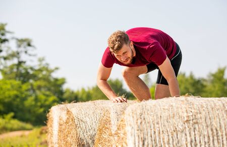 Haystack obstacles at the extreme race overcome by runner