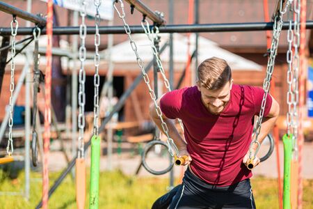 Hanging rings obstacle overcome by runner at the extreme race