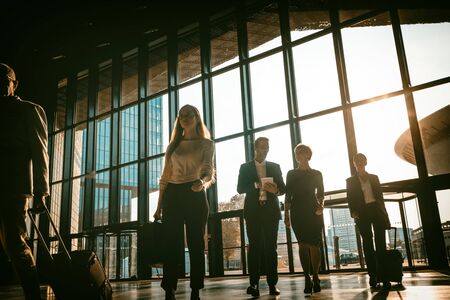 Group of business people walking in airport hallの写真素材