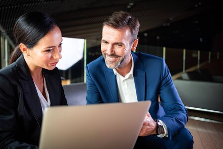 Businessman And Businesswoman Meeting In Modern Officeの写真素材