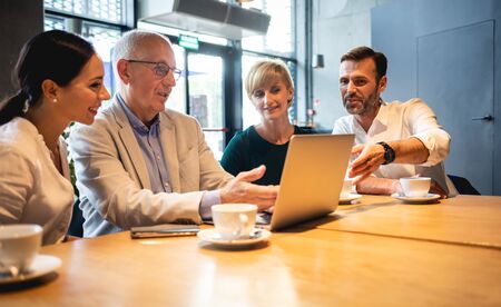 Business people talking about project in a cafeの写真素材