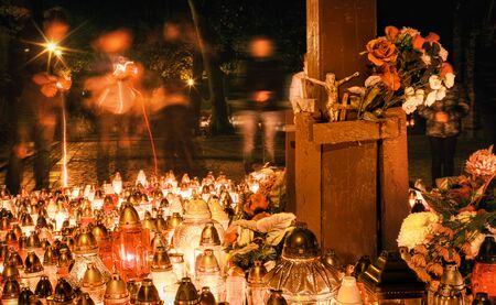 Many candles burning in lanterns at night during All Saints Dayの写真素材