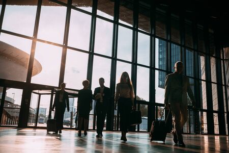 Group of business people walking in airport hallの写真素材