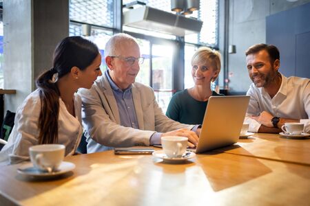Business people talking about project in a cafeの写真素材