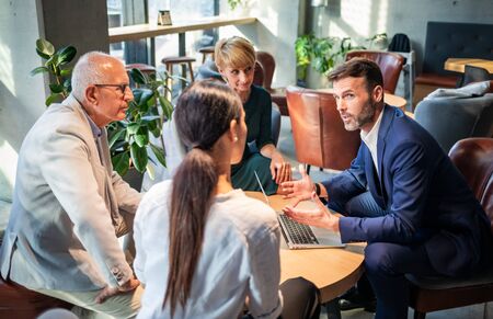 Group of business people meeting during coffee time