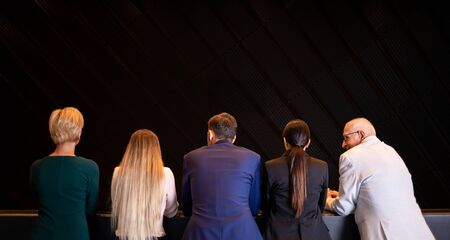 Group of business people at modern conference hall back viewの写真素材