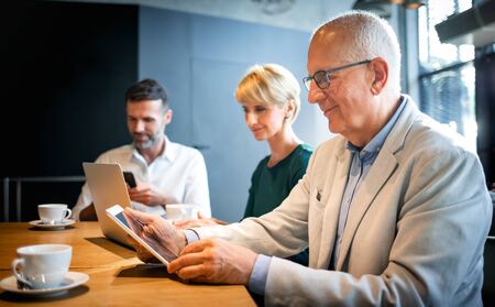 Businessman using digital tablet during meeting in cafeの写真素材