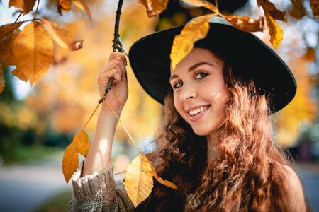 Young woman walking outdoors in autumn enjoying weatherの写真素材
