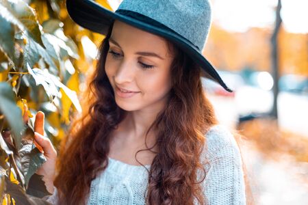 Young woman walking outdoors in autumn enjoying weatherの写真素材