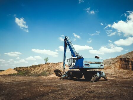 Industrial excavator working on construction siteの写真素材