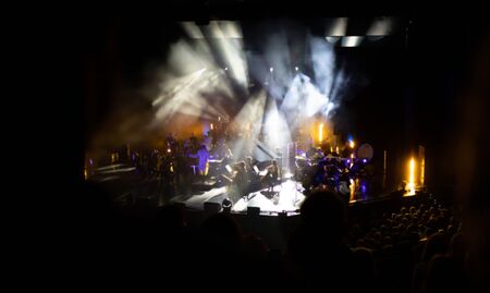 Lights on stage during concert in hall filled with spectatorsの写真素材