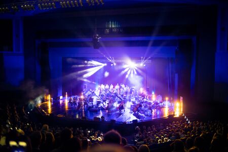 Lights on stage during concert in hall filled with spectatorsの写真素材
