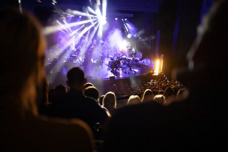 Lights on stage during concert in hall filled with spectatorsの写真素材
