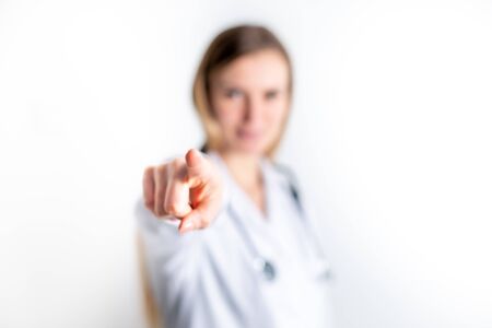 Young female doctor with pointing finger gestureの写真素材