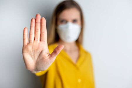 Virus mask woman wearing face protection in prevention for coronavirus showing gesture Stop Infectionの写真素材