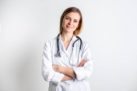 Medical concept of young female doctor in white coat with stethoscopeの写真素材
