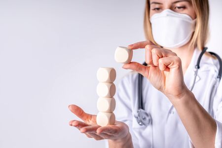 Healthcare concept blank wooden blocks in hand of female doctor copy spaceの写真素材