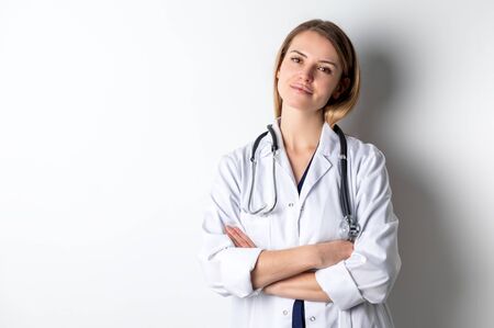Medical concept of young female doctor in white coat with stethoscopeの写真素材