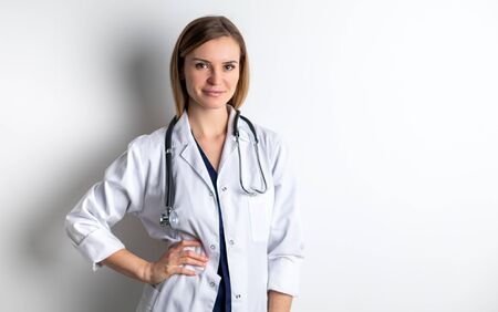 Medical concept of young female doctor in white coat with stethoscope copy spaceの写真素材