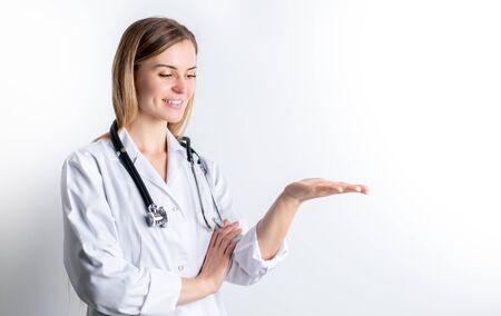 Medical concept of young female doctor in white coat with stethoscope copy spaceの写真素材