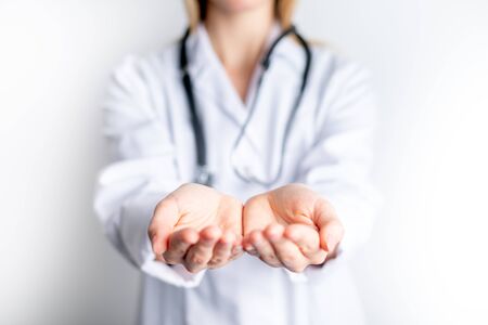 Female doctor presenting blank palm of her hand holding something copy spaceの写真素材