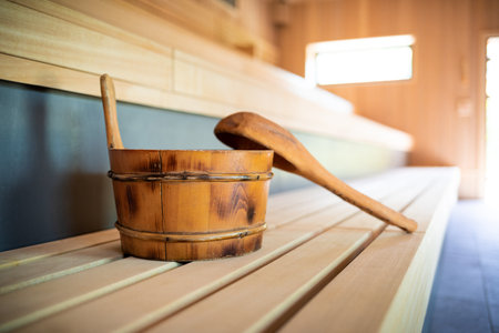 Wooden sauna accessories laying on benchの写真素材