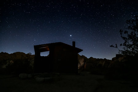 Night starry sky over abandoned house in the mountains. Long exposure.の写真素材