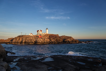 Lighthouse on a rock in the sea at sunset, Portugal.の写真素材