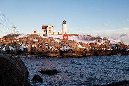 Lighthouse on a rocky island in winter. Lofoten islands, Norwayの写真素材