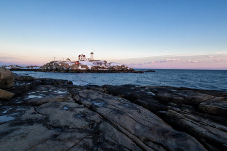 Lighthouse on the rocks at sunset, Cape St. Vincent, Newfoundland and Labrador, Canadaの写真素材