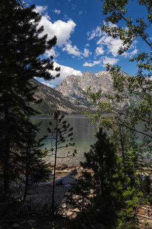 Mountain landscape with lake and forest on a background of blue skyの写真素材