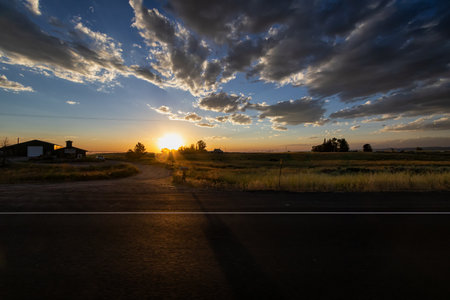 Sunset over a country road in the rural area of Colorado.の写真素材