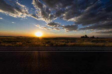 Sunset in the steppe. The road through the steppe.の写真素材